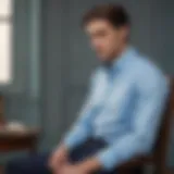 Elegant light blue Oxford shirt draped over a vintage chair