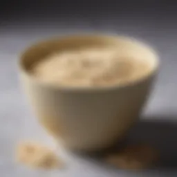 A close-up of blonde bleach powder in a stylish bowl