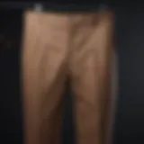 Diverse styles of formal trousers displayed on hangers