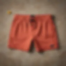 A collection of stylish summer shorts in various colors and fabrics laid out on a vibrant surface